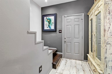 Front entry of home features distressed wood looki
