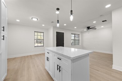 Kitchen area with an island to give it that opened