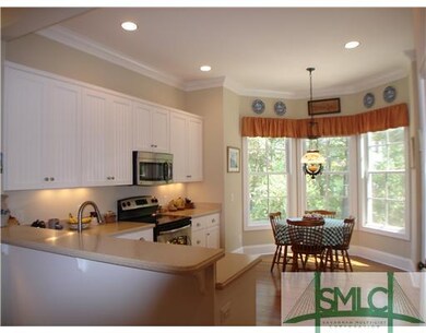Kitchen. Kitchen features white cabinetry and hard