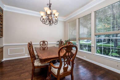 Generously sized dining room with wood floors and built-in dry bar.