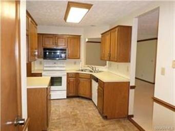 A well designed kitchen with lots of cabinets and 