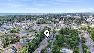 Aerial overview of property's location with a large body of water and nearby suburban area