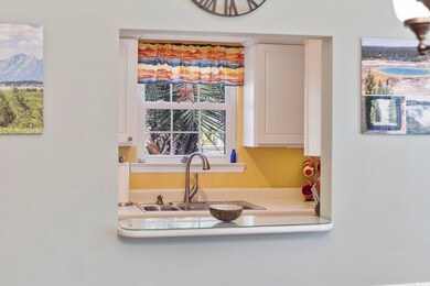 Kitchen featuring white cabinets, a mountain view,