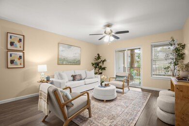 Living room with a ceiling fan, baseboards, and d