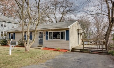 Front view with deck and driveway