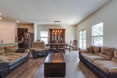 Living area featuring healthy amount of natural light, recessed lighting, and dark wood-type flooring
