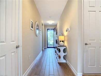 Hall with hardwood / wood-style flooring