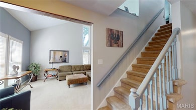 Stairs with carpet floors and high vaulted ceiling