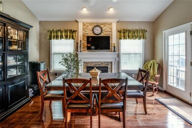 Another fireplace adorns this bright dining area!