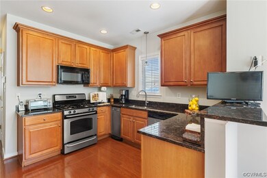 The gourmet Kitchen has granite counters, gas cook