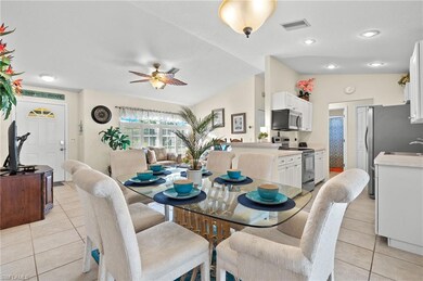 Tiled dining room featuring ceiling fan, sink, and
