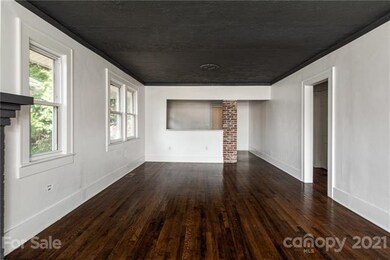 Living room opens to dining room and kitchen with eat in bar, refinished oak floors