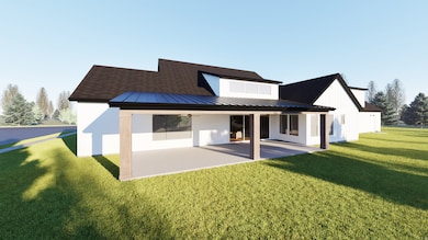 Back of house with a standing seam roof, a metal roof, a yard, and a patio