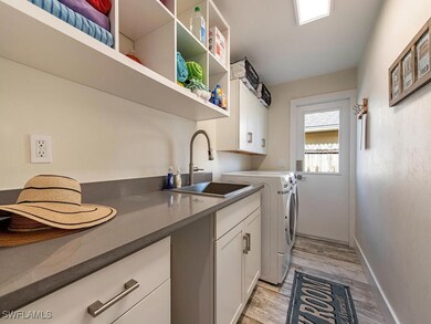 Laundry room featuring cabinets, light hardwood /
