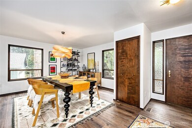 Entry way flows into the formal dining area. Amazing custom chandellier.