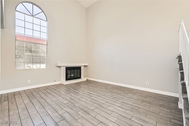 Unfurnished living room featuring a high ceiling,