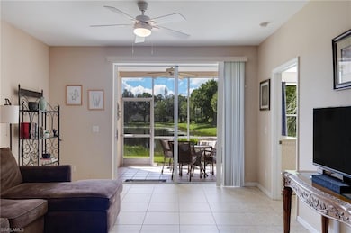 Living area featuring light tile patterned flooring, plenty of natural light, and ceiling fan