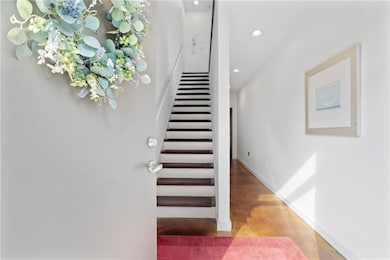 Stairway with finished concrete flooring and recessed lighting