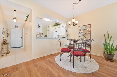 Dining area featuring light wood-style flooring and a chandelier