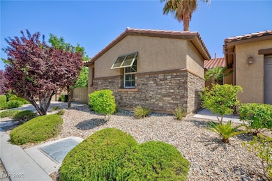 View of property exterior featuring stucco siding, stone siding, and a tiled roof