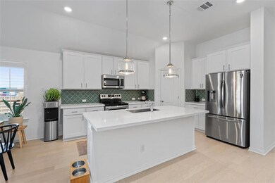 Kitchen featuring appliances with stainless steel