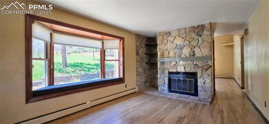 Unfurnished living room featuring a baseboard radi