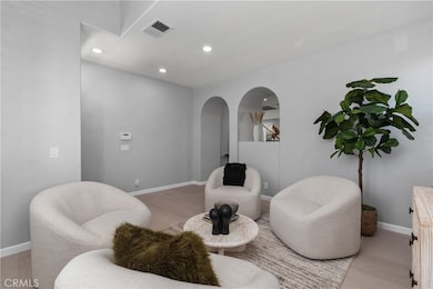 LIVING ROOM.  NEW FLOORING.  NOTICE ARCHWAY IN THE BACKGROUND THAT LEADS TO THE FAMILY ROOM, KITCHEN AND STAIRS.