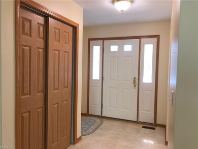 A view of the front door and hall coat closet.  Th