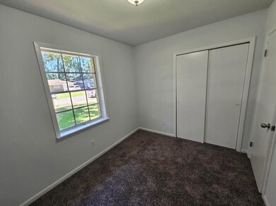 Bedroom features new paint and carpet.