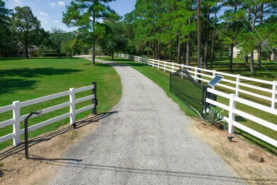 Gated entrance to the property with PVC fencing.