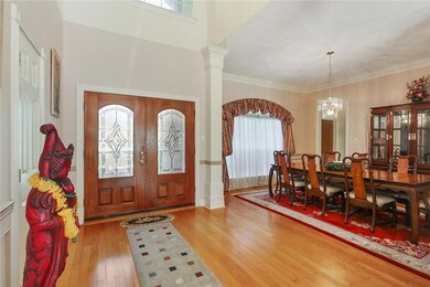 Great big Foyer with wood floors opening up to the