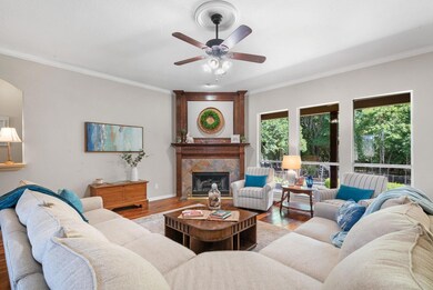 Living room with a fireplace, crown molding, ceili