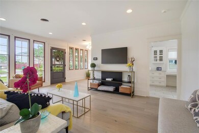 Bright living room with sunporch can be used as gr