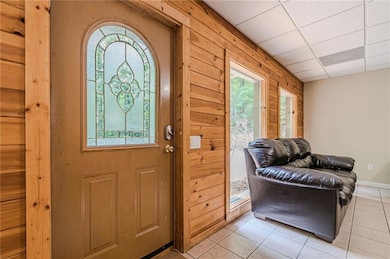 Entryway with light tile patterned flooring and a 