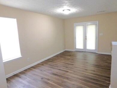 Unfurnished room featuring french doors, wood fini
