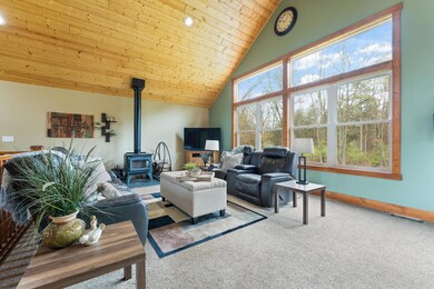 Large Windows overlook wooded acreage