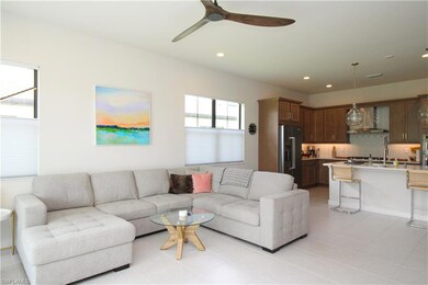 Tiled living room featuring ceiling fan