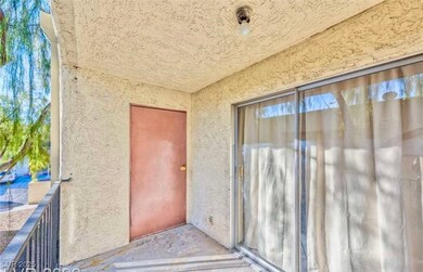 Entrance to property with stucco siding and a balc