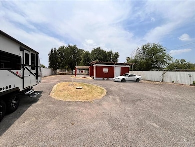 View of yard with asphalt driveway