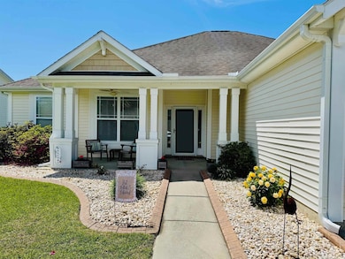Entrance to property featuring a porch and roof wi