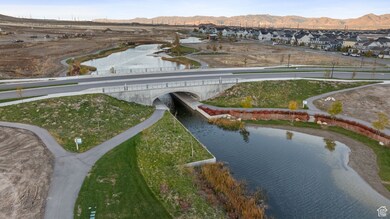 Aerial perspective of suburban area featuring a notable bridge and a water and mountain view