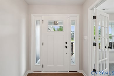 Foyer entrance featuring dark wood-style floors