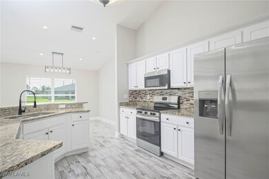 Kitchen with white cabinets, stainless steel appli