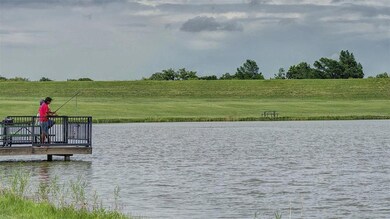 Dock area with a yard and a water view