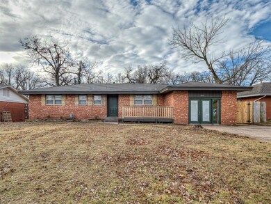 Ranch-style home with a front yard, french doors, 
