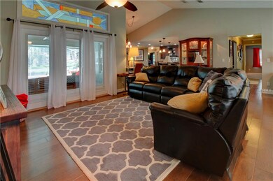 Family room with wood floors & French doors leadin