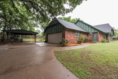 Desirable side garage entry with carport.
