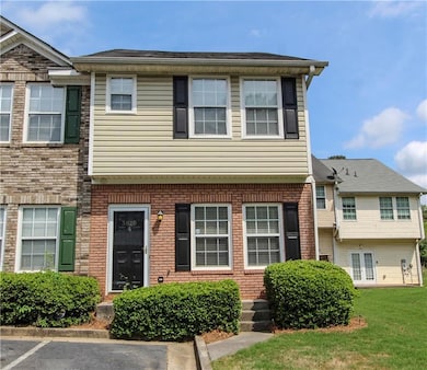 Multi unit property featuring a front lawn and unc