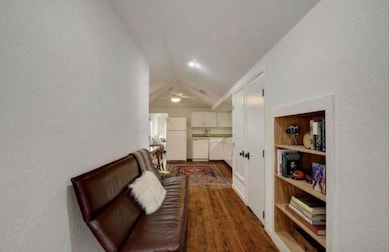 Living area with vaulted ceiling, ceiling fan, an