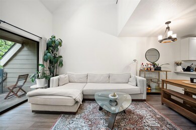 Living area with light wood-style flooring, a cha